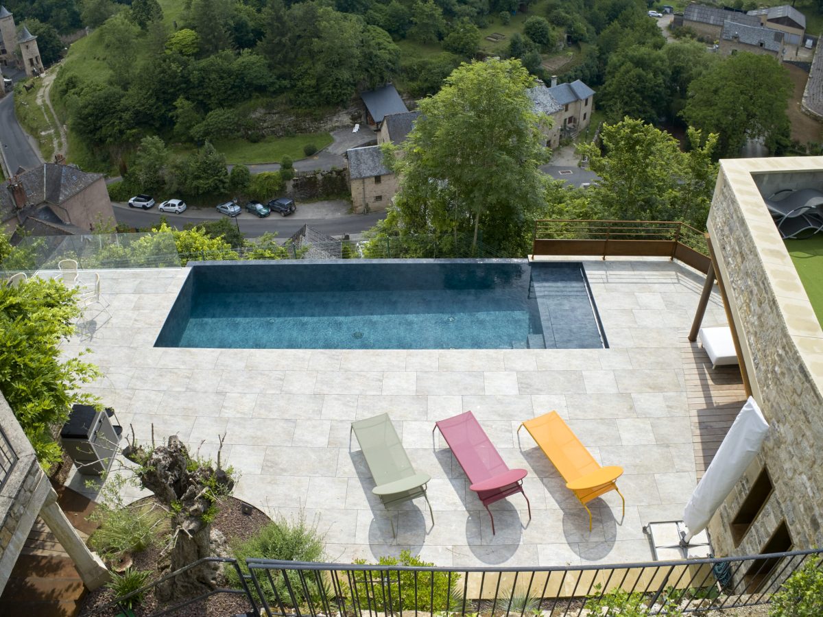 Piscine à débordement sur la largeur de 9 x 3.5 m, profondeur 1.20 à 1.80m avec escalier d’angle et banquette volet